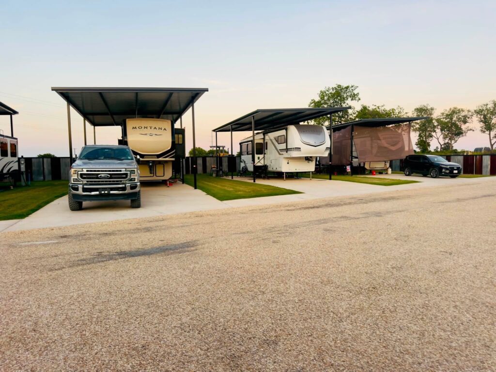 Covered RV site with room for a truck at Magnolia RV Resort