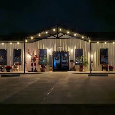 Main building with string lights at night at Magnolia RV Resort