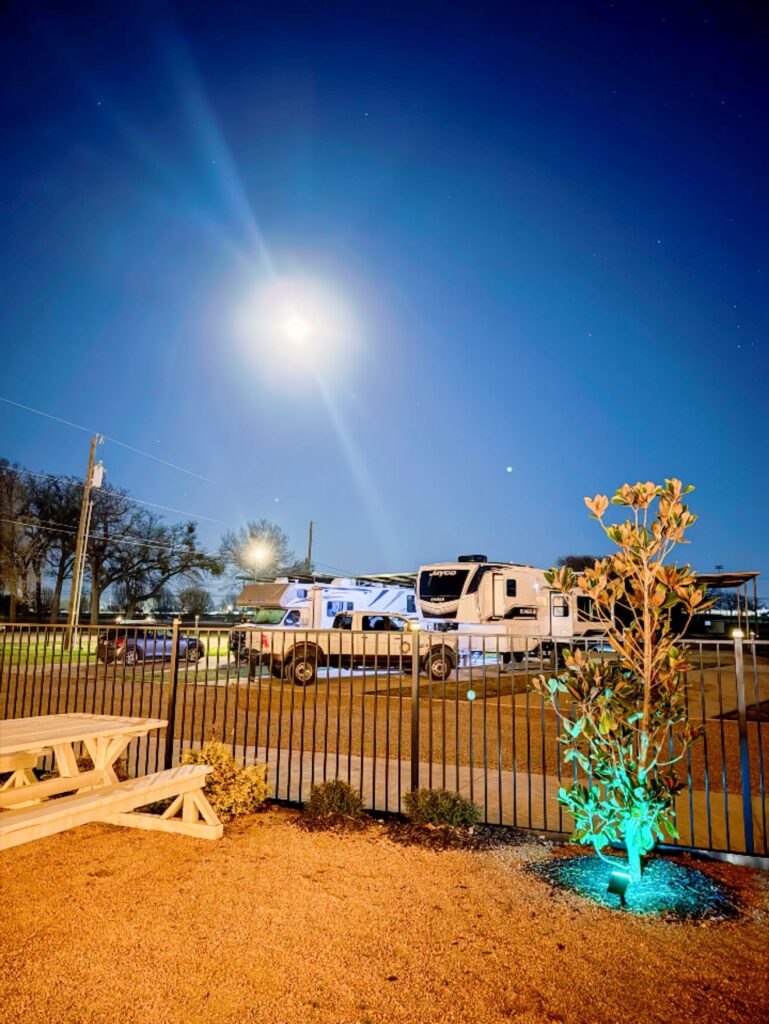 RV sites and landscape lighting at night at Magnolia RV Resort